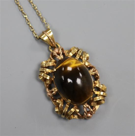 An Austrian yellow metal and tigers eye quartz set pendant, on a yellow metal chain, pendant 30mm.